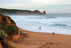 Guests can enjoy fishing on the natural beach, bordered by a cliff and rocky outcrop.