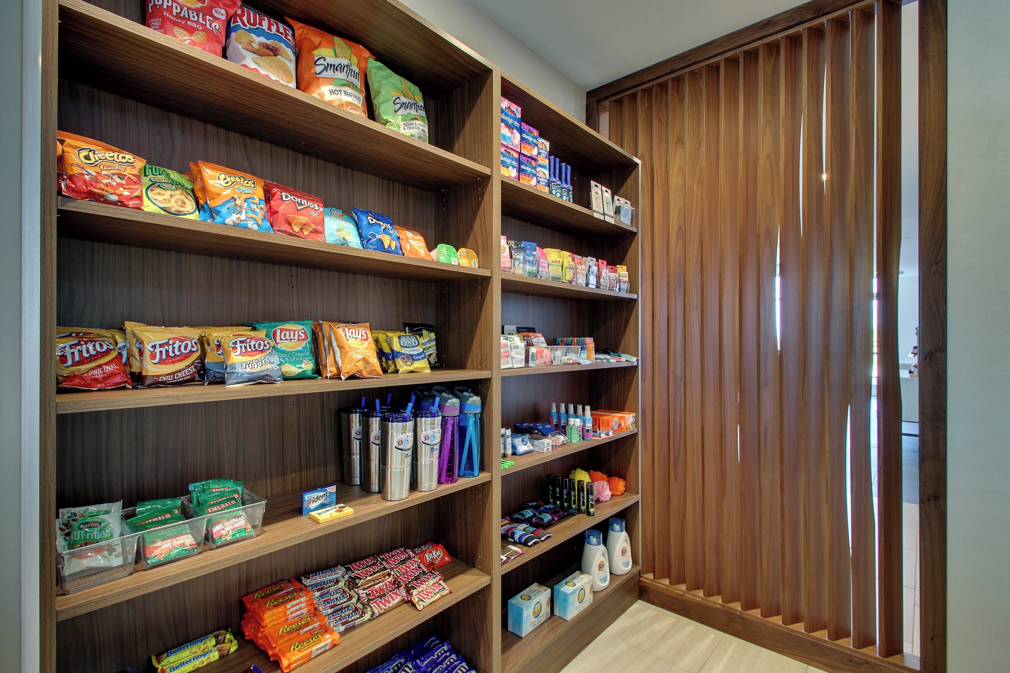 A pantry stocked with snacks and beverages, including chips, cookies, and bottled water.