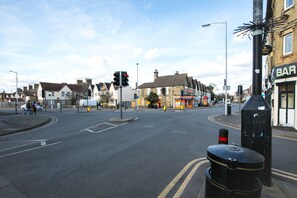 A street intersection with a traffic light, a roundabout, and a bar on the right. - KVM - City Apartments (Peterborough)