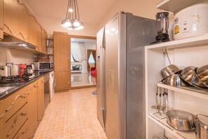 A kitchen with a refrigerator, microwave, and stove.