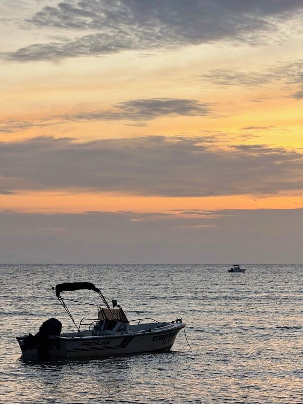 Un barco llamado "PROVIDENCE" en aguas tranquilas durante la puesta de sol.