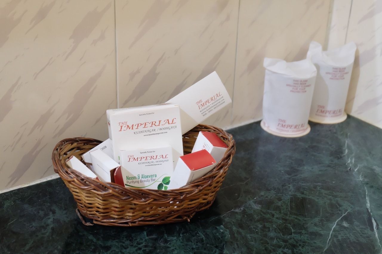 A wicker basket containing boxes labeled "The Imperial Neem & Aloe Vera Purifying Beauty Bar" on a marble countertop.