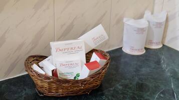A wicker basket containing boxes labeled "The Imperial Neem & Aloe Vera Purifying Beauty Bar" on a marble countertop.