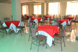 A dining hall with multiple tables and chairs, arranged in rows. - Starehe link hotel (Nairobi)