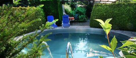 Seasonal outdoor pool, pool loungers
