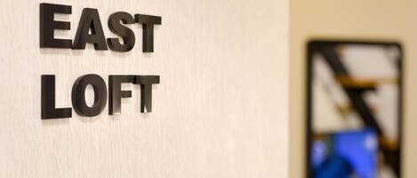 A wall with the words "EAST LOFT" in bold letters.