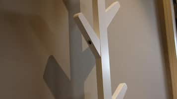 A white, abstract wall art piece with a vertical, branching design.