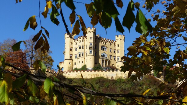 A castle with multiple towers and a balcony, surrounded by trees and greenery. - Spacious, inviting apartment near Füssen  close Neuschwanstein castle (Hopferau)