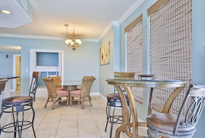 Guests can dine in comfort at this cozy dining area, surrounded by a round table and four cushioned chairs.