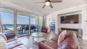 A spacious living area with a large sliding glass door leading to a balcony with a view of the beach. - Boardwalk 4BR/3 Bath **2nd Floor** End Unit (Panama City Beach)