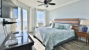 A hotel room with a bed, a desk, a television, and a view of the ocean. - 1st floor 3br Marisol unit sleeps 8! (Panama City Beach)