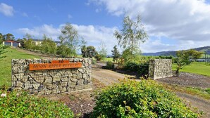 A stone gate with a sign reading "MOCON RIVER RETREAT" and a number "20" on it. - Moon River Retreat - Panoramic water views (Gardners Bay)