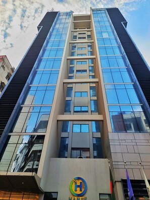 A high-rise building with a prominent Hansa logo at the base. - HANSA - A Premium Residence (Dhaka)