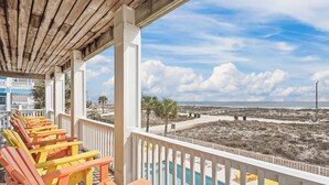 A beachside balcony with a pool, wooden chairs, and a view of the beach and ocean. - Luxury 6 Bdrm/6 Ba Gulf Front w/Private Pool and Great Views (Gulf Shores)