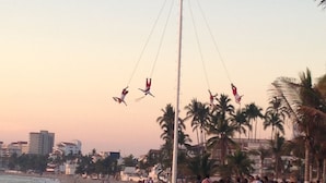 A beach with a swing ride, palm trees, and a crowd of people. - Ocean View - In the Heart of Old Town -Casa Romance Escondido (Puerto Vallarta)