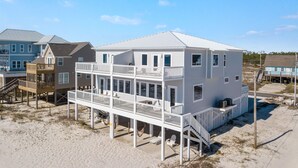 A beachfront house with multiple decks and a covered outdoor area. - East Side of Updated, Gorgeous 4 BR Gulf Front Duplex. (Gulf Shores)