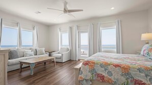 A bedroom with a bed, a sofa, a chair, and a coffee table. - East Side of Updated, Gorgeous 4 BR Gulf Front Duplex. (Gulf Shores)