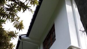 A two-story building with a balcony on the second floor. - Enrich Bungalow (Kandy)