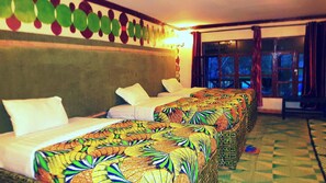 Relax in a cozy room with a long, narrow bed arrangement and a checkered floor.