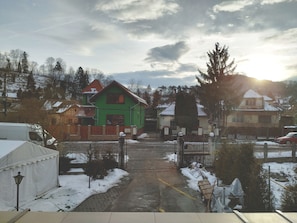A snowy residential area with houses, a gate, and a tent. - Venesis House (Sighisoara)