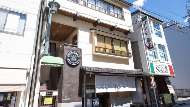 A two-story building with a coffee shop on the ground floor.