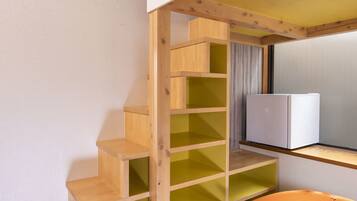 A multi-level wooden staircase with green and yellow steps leading to a lower level.