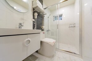 Shower, hair dryer, slippers, towels