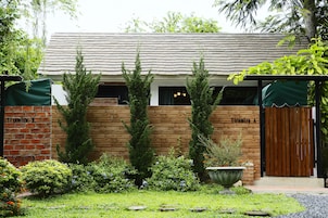 A brick building with a wooden facade, a wooden door, and a green awning.