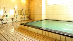 A swimming pool with tiled walls and a tiled floor, equipped with multiple showerheads and a visible water level indicator. - Hakuba Tsugaike Sunrise TANNE (Otari)