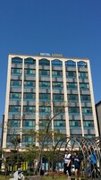 A modern hotel building with a sign reading "HOTEL LOHAS".