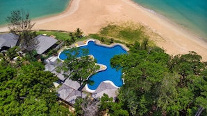An aerial view of a resort with a swimming pool, beach, and lush greenery. - Borneo Eagle Resort (Kota Kinabalu)