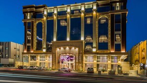 A multi-story hotel with a grand entrance, large windows, and a well-lit facade. - Boudl Quraish (Jeddah)