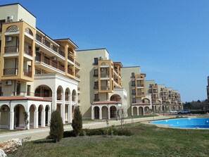 A row of multi-story hotel buildings with balconies and arched windows. - Lighthouse Luxe Estate Apart & Villas (Balchik)