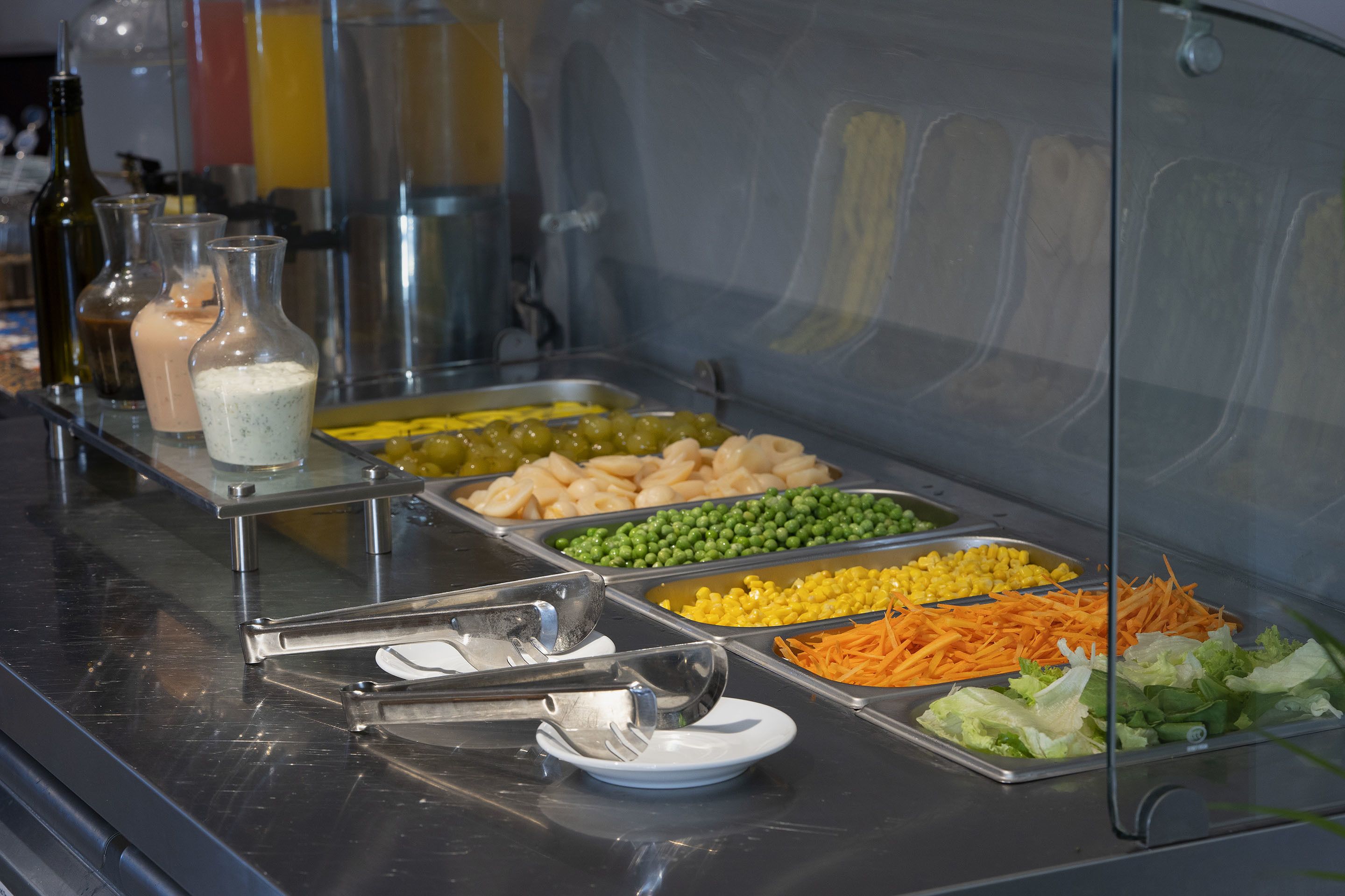 A buffet with various food items including fruits, vegetables, and dips.