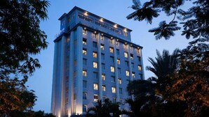 A multi-story hotel with a modern design, featuring a prominent entrance and uniform window patterns.