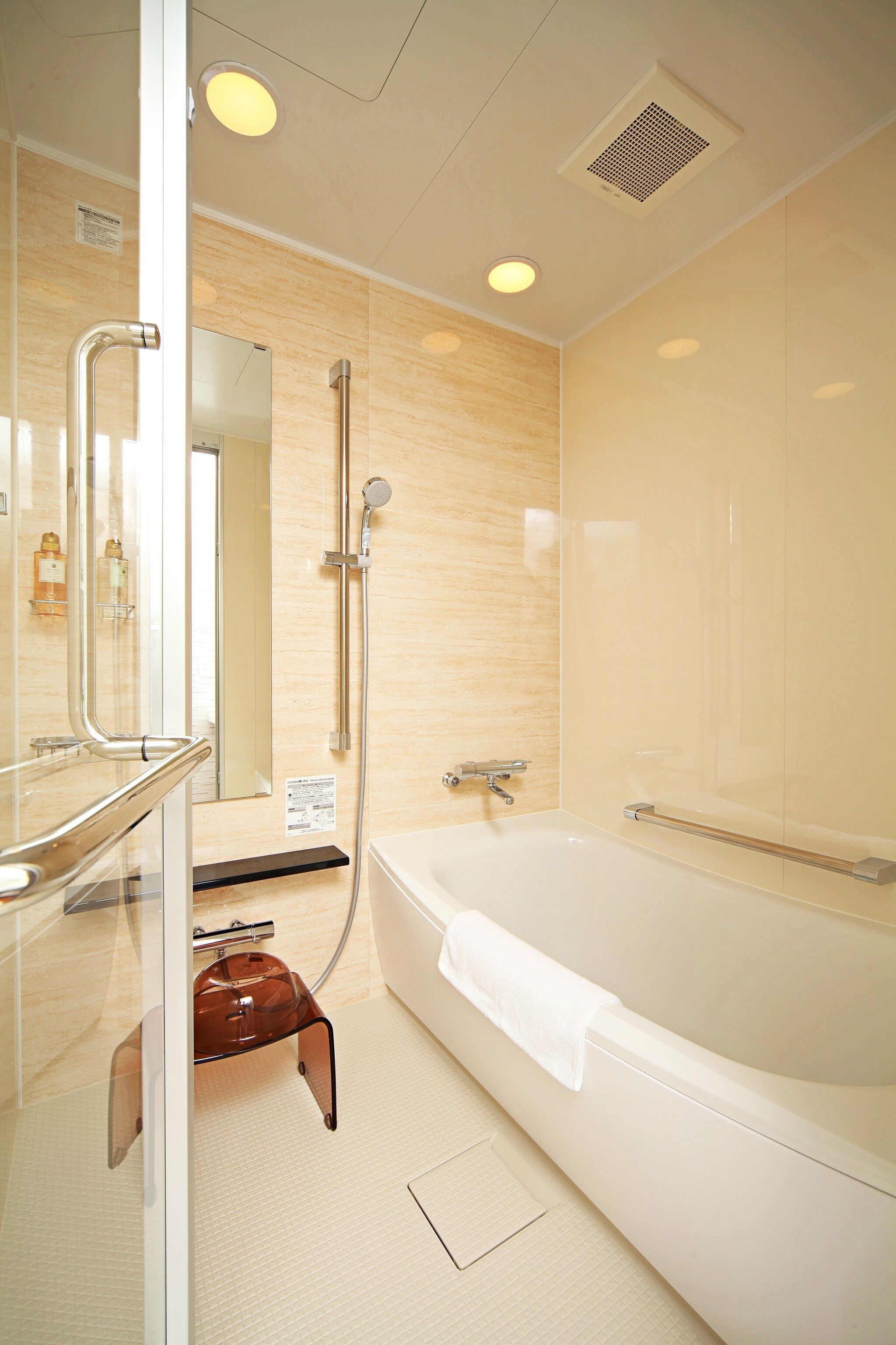 A modern bathroom with a bathtub, a glass shower enclosure, and a vanity with a mirror.