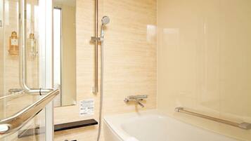A modern bathroom with a bathtub, a glass shower enclosure, and a vanity with a mirror.