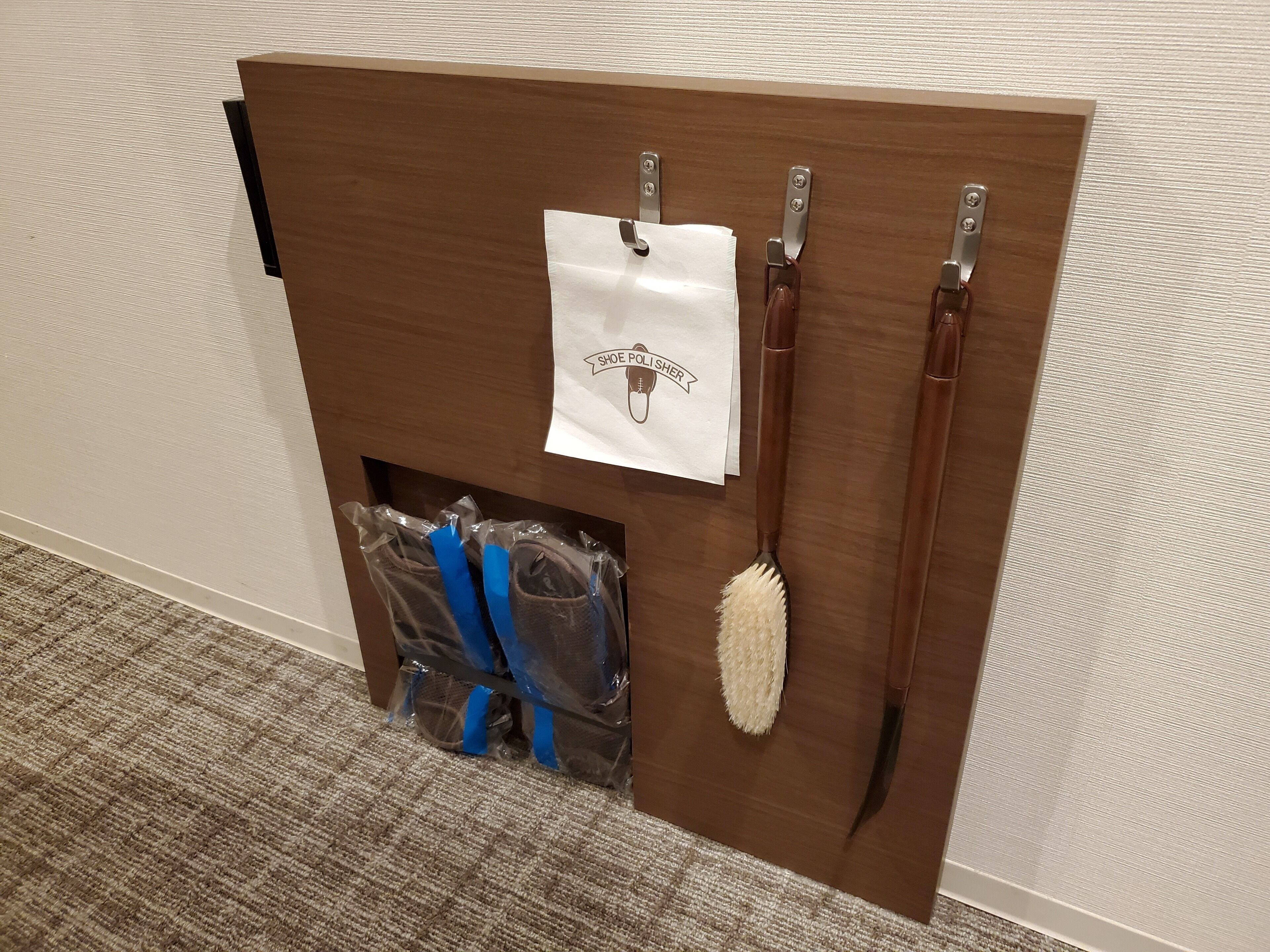A shoe polish station with a white bag, brushes, and shoe polish bottles.