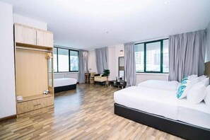 A hotel room with a bed, a desk, a chair, and a wardrobe. - Metropol Hotel (Kuala Lumpur)