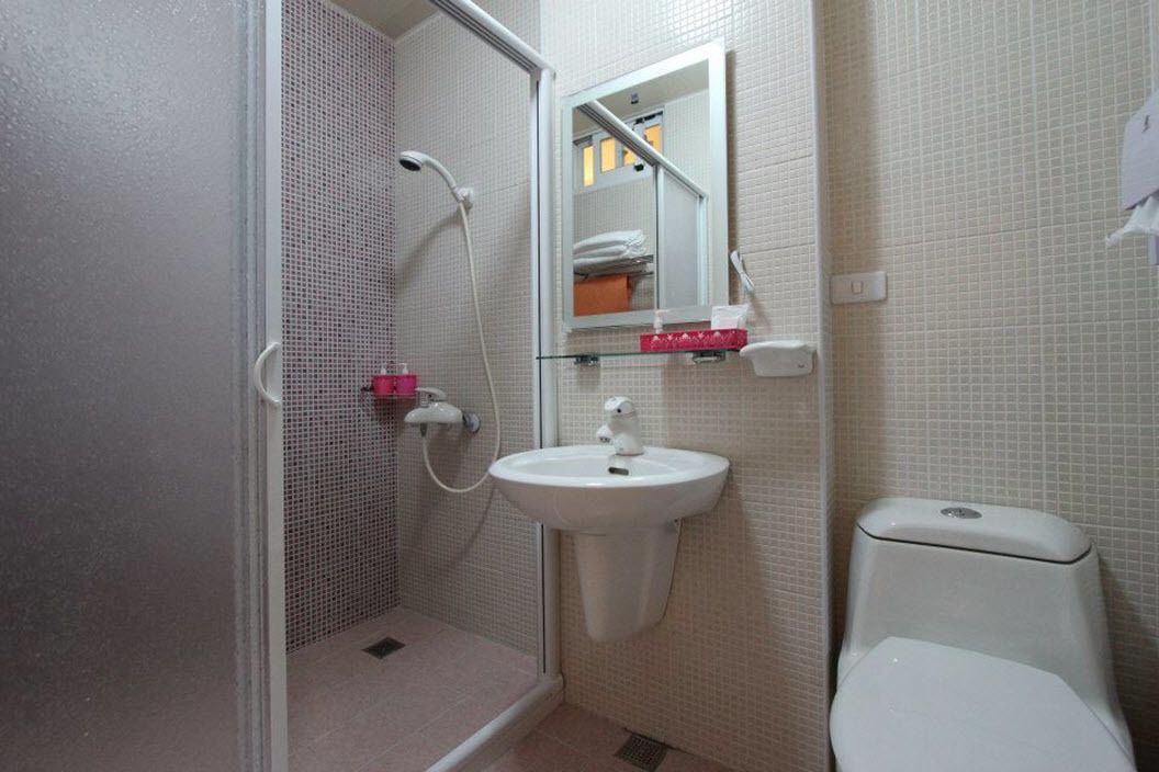 Une salle de bain avec une douche, un lavabo et des toilettes.