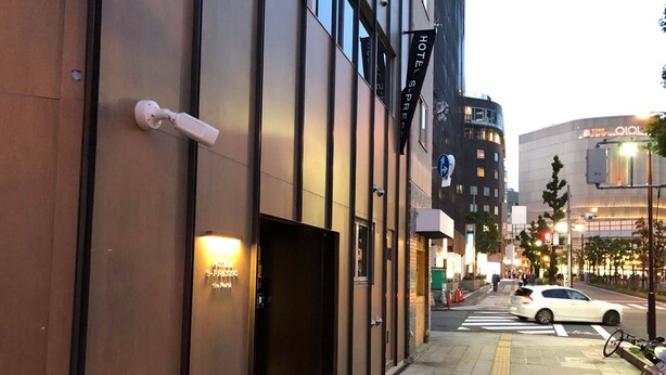 A modern hotel entrance with a visible door and a sign indicating the name. - Hotel S-Presso North (Osaka)