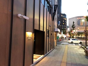 A modern hotel entrance with a visible door and a sign indicating the name. - Hotel S-Presso North (Osaka)