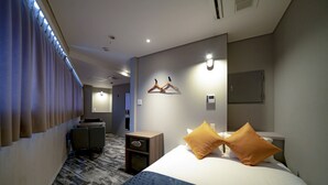 A hotel room with a bed, a nightstand, a desk, a chair, and a coat rack. - Hotel S-Presso North (Osaka)