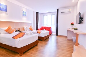 A hotel room with two beds, a red sofa, a desk, and a TV. - Marlin Hotel (Surat Thani)