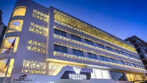 A modern hotel with a distinctive facade featuring circular patterns and the name "WHITE LINE" prominently displayed. - White Line Boutique Hotel (Elazig)