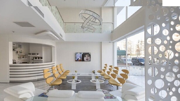 A modern lobby with a central seating area, a reception desk, and a staircase. - White Line Boutique Hotel (Elazig)