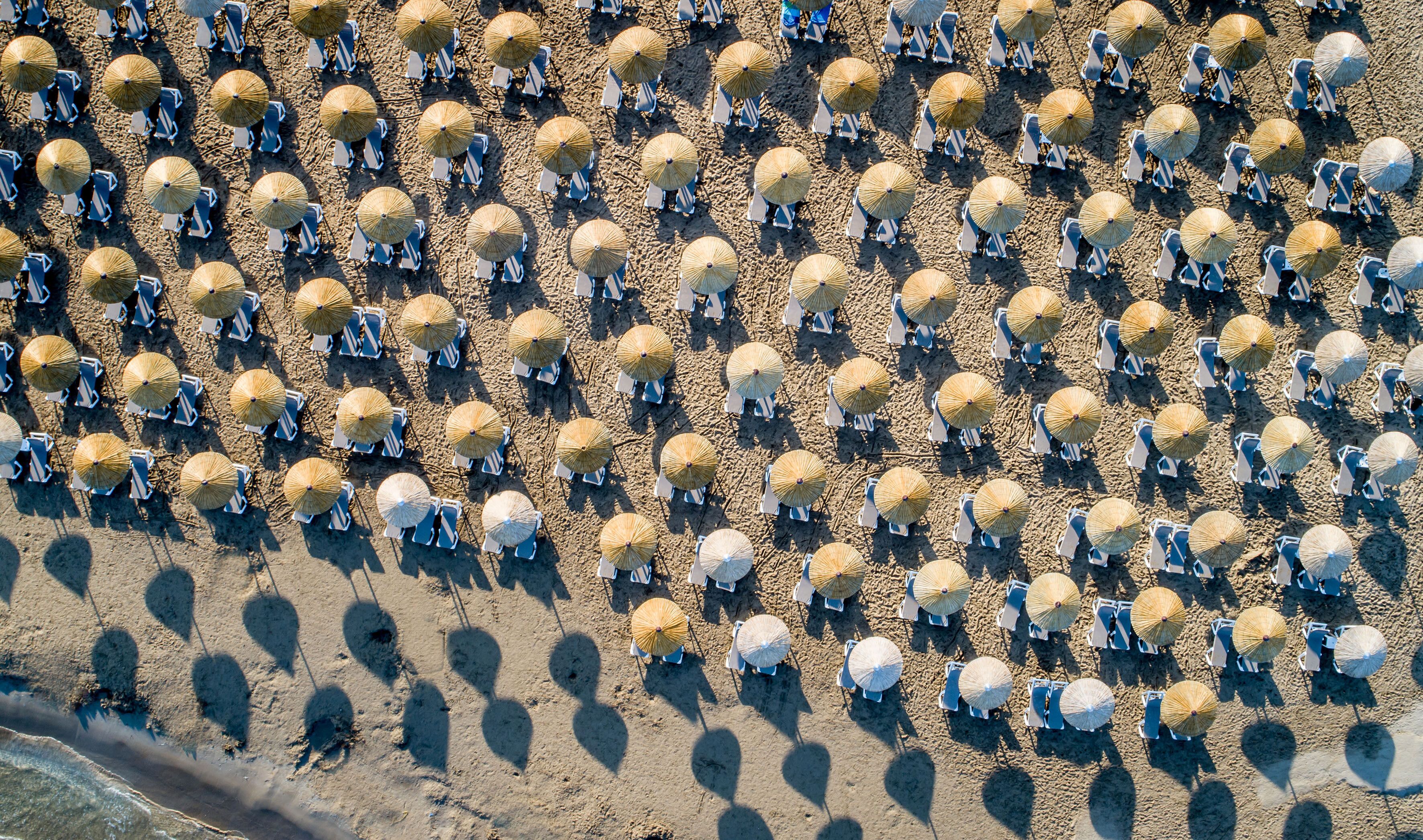 on the beach, sun-loungers, beach umbrellas, beach towels