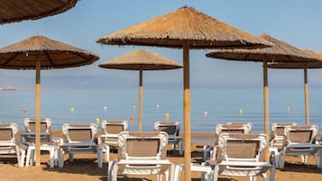 On the beach, sun-loungers, beach umbrellas, beach towels