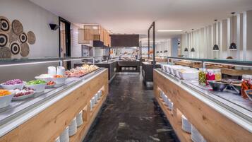A modern buffet setup with various food items and a central serving area.