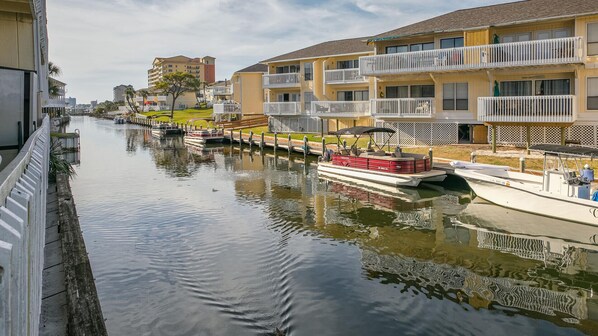 A canal with boats, waterfront buildings, and a view of the city skyline. - Canal Views! Free Beach Service, Pet Friendly! Sandpiper Cove 4100! (Destin)